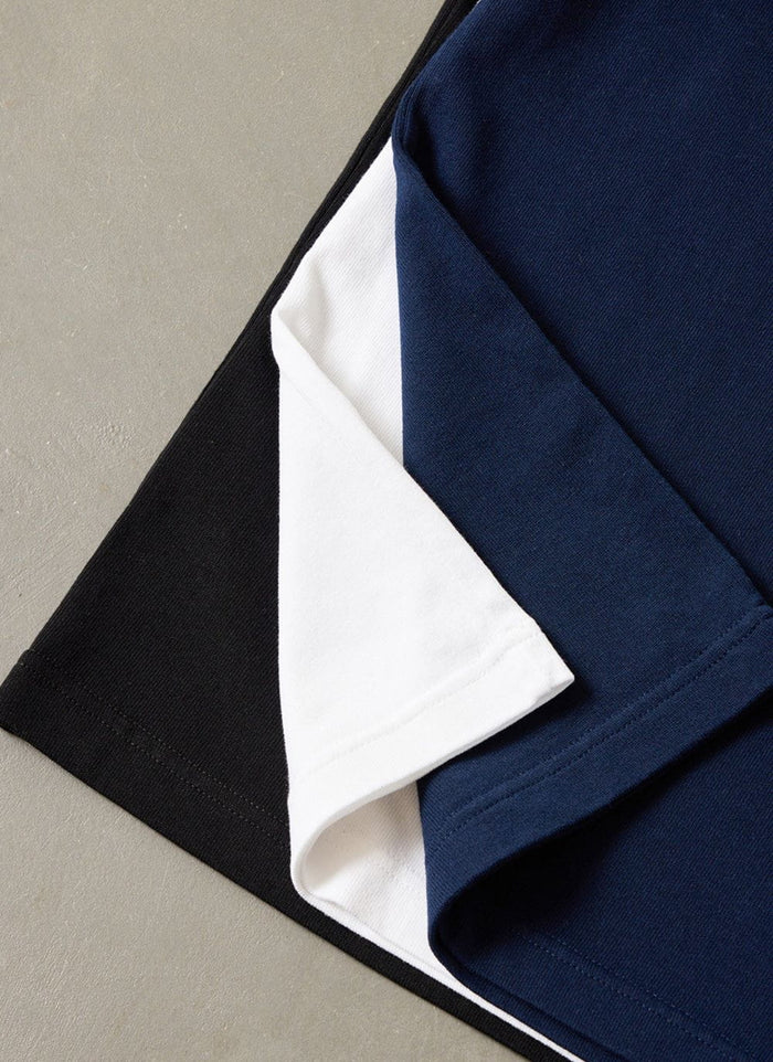 Close up of the organic cotton fabric of the Percival oversized t-shirt 3 pack in black, white, and navy.