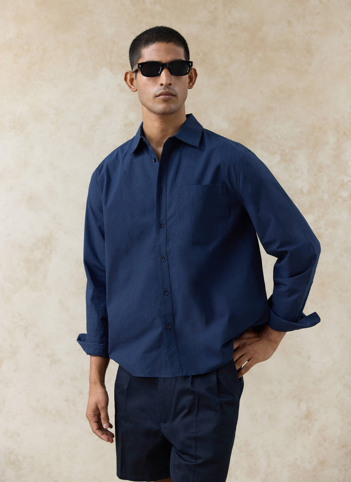 Navy Percival Dali Relaxed Poplin Shirt in paper-touch cotton, featuring a chest pocket and relaxed fit on a model.