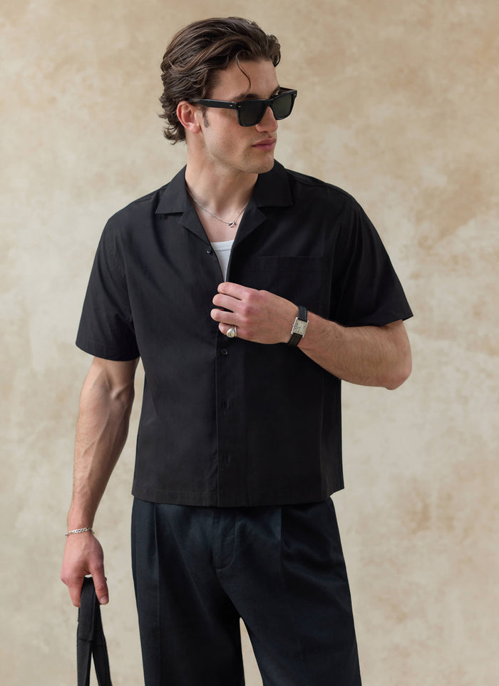 Black cotton Percival Daniel Boxy Cuban Shirt, featuring a short-sleeved relaxed fit styled on a model.
