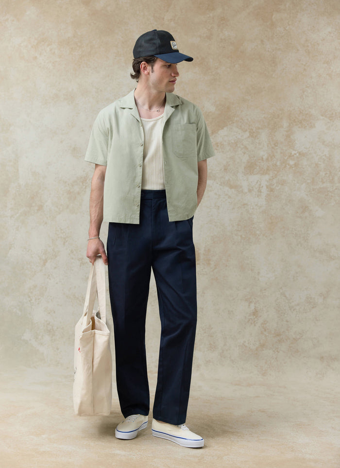 Pistachio cotton Percival Daniel Boxy Cuban Shirt styled with navy trousers from our new collection; want more?