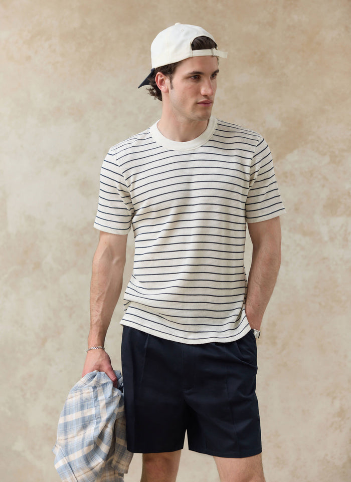 Percival Ernie Waffle T-Shirt in cream stripe and Donovan Soft Trucker Cap worn by a model with navy shorts.