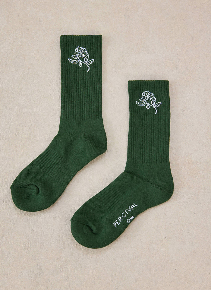 A pair of forest green Percival Earl Jacquard socks with white floral patterns.