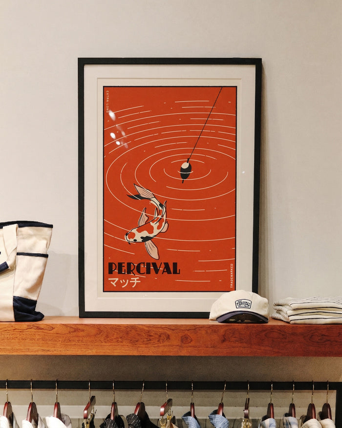 The framed Percival Koi Fish Giclée fine art print displayed on a wooden shelf in store.