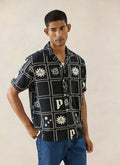 Percival Lunar Panel Cuban Shirt in black viscose with a white celestial graphic print, styled on a model with blue jeans.