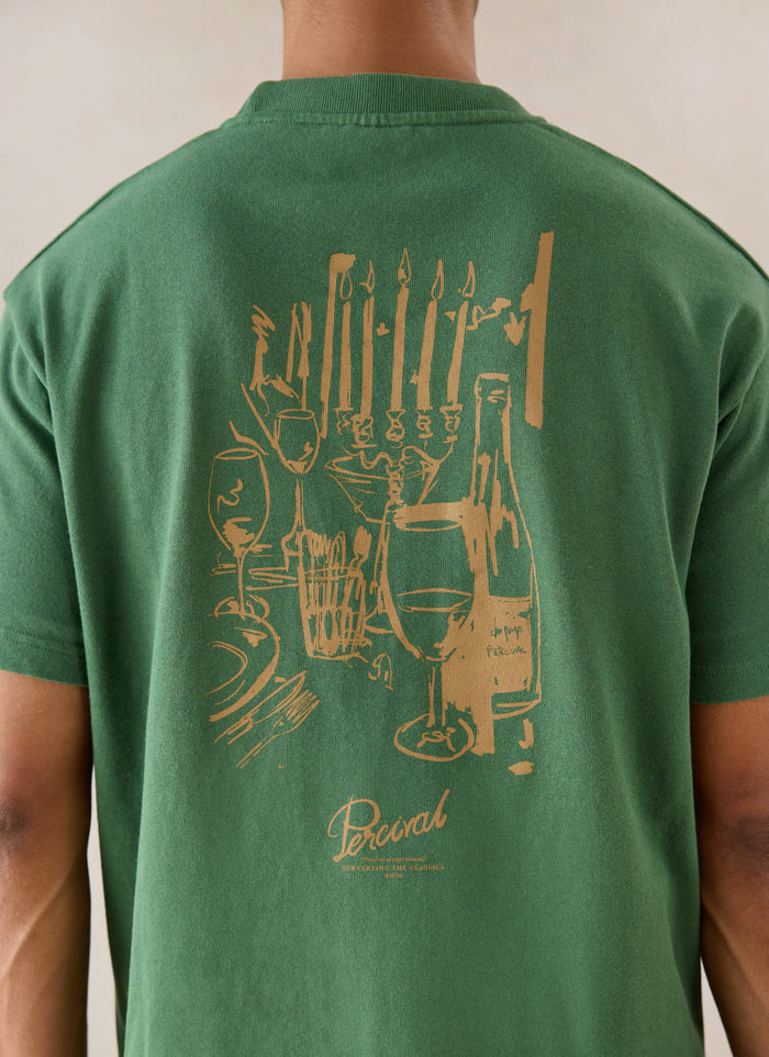 Forest green Percival Marley oversized T-shirt, featuring a dinner party back graphic, shown from behind on a model.