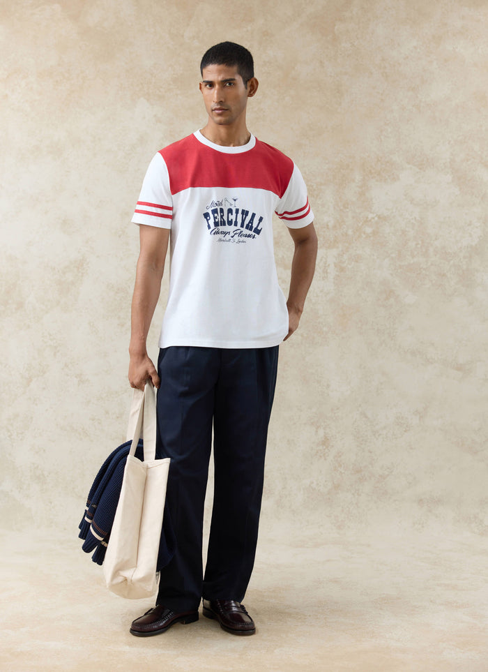 A model wears the organic cotton Motel Percival T-shirt in white and red with a contrast yoke and sleeve stripes.