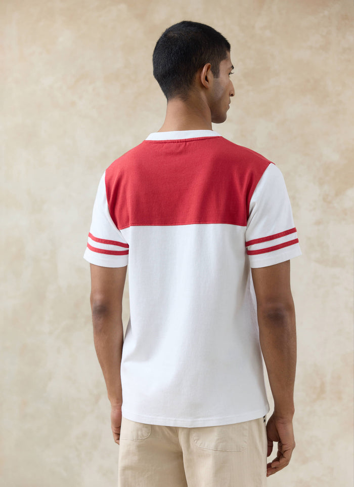Rear view of the white organic cotton Motel Percival T-shirt featuring a red contrast yoke and sporty sleeve stripes.