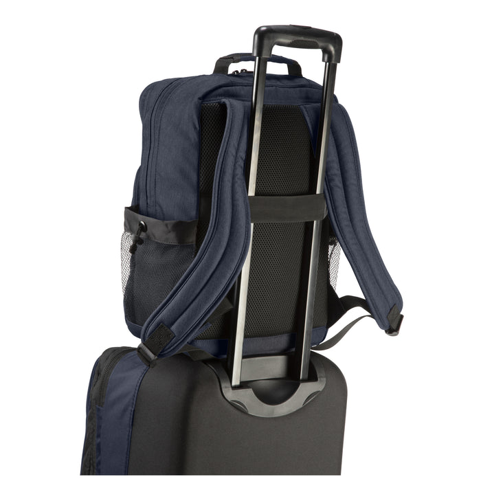 heather navy oslo backpack on a suitcase