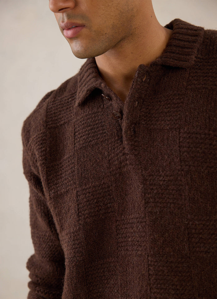 Close-up of a model wearing the brown Percival Shugart Knit Jumper, highlighting the knitted collar and textured blend.