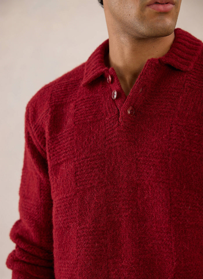 A close-up of a model wearing the merlot Percival Shugart Boxy Knit Jumper, showcasing the button collar and textured knit.