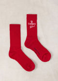 Flat lay of red Guinness x Percival cotton blend crew socks featuring white logo detailing.