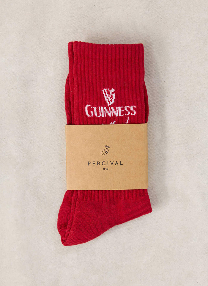 Red Guinness x Percival cotton blend crew socks packaged with a branded cardboard band showing the logo.