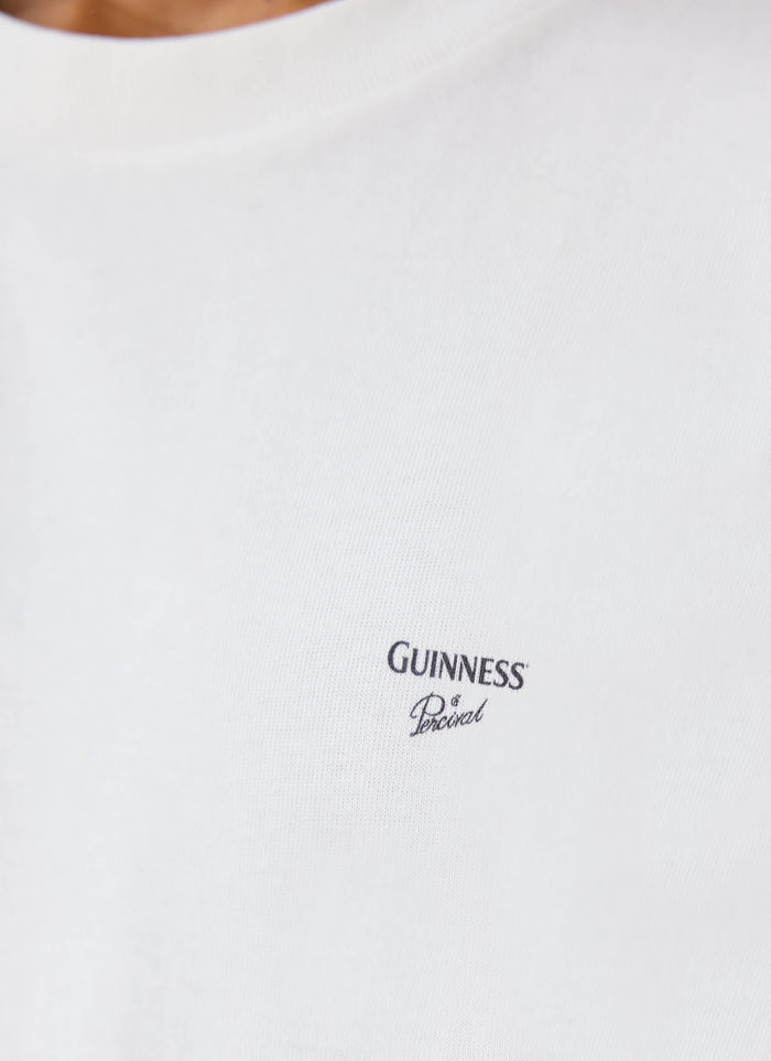 A close-up of the white Guinness x Percival Soloist T-shirt showing the printed chest logo.
