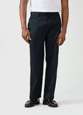 A model wears the black Straight Leg Twill Trousers by Percival, styled with a white t-shirt and leather loafers.