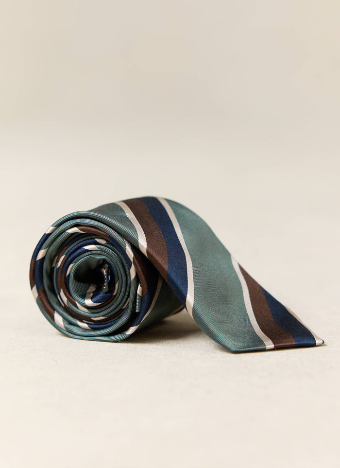 Percival Stripe Tie | Silk | Multi, a rolled-up forest green silk tie featuring navy, brown and cream stripes.