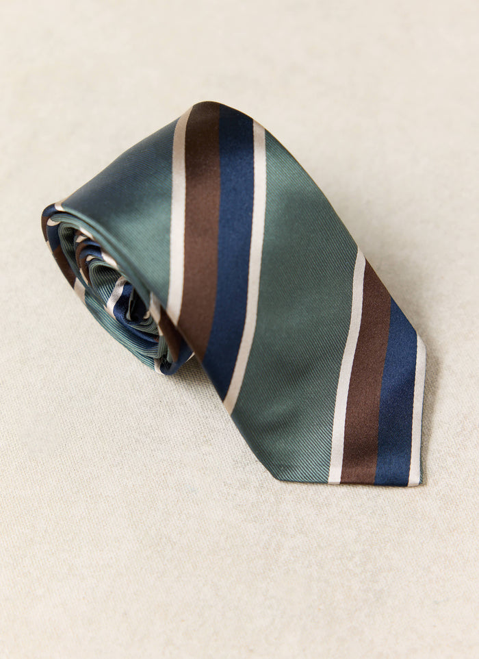Percival Stripe Tie | Silk | Multi, featuring forest green, navy, brown and cream diagonal stripes, shown rolled up.