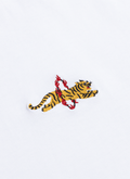 Close-up of the embroidered flaming tiger detail on the white organic cotton Tiger T-shirt by Percival.