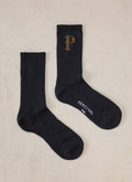 Black Percival Tucker embroidered crew socks in a flat lay, featuring a ribbed cotton blend and gold embroidered P detail.