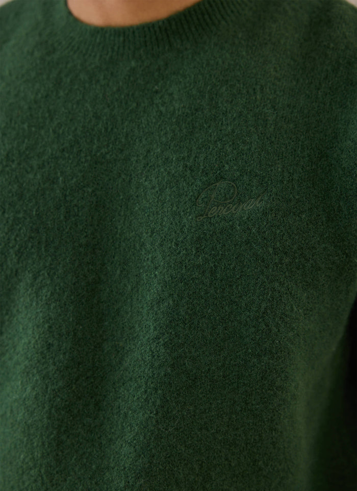 Close-up of a model wearing the forest green Percival mohair jumper, showing the texture and chest detail.